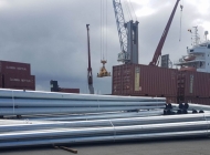 Steel telegraph poles ready for loading onto vessel